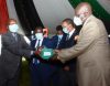 CS Education Prof. George Maghoha (right) presents a purse containing a padlock and a keys which will be used to lock examination containers to West Pokot Sub-County Director of education Charles Manyara at Kenya School of Government.